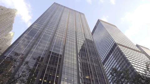Glass windows office building skyscraper with tress upward angle Manhattan NYC 動画素材 70964400