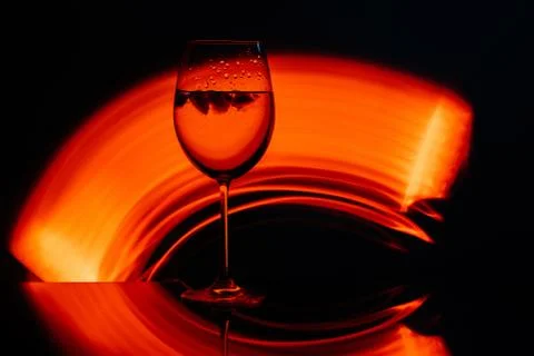 Glass for wine against the backdrop of bright color solutions Stock Photos