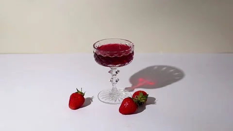 Glass of wine and strawberries on the table on a sunny day. Stock-Footage 237241091