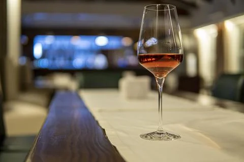 Glass of wine on an empty table Stock Photos
