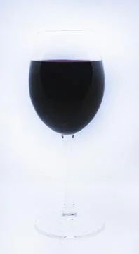 Glass wine glass on a white background. Red wine. Stock Photos