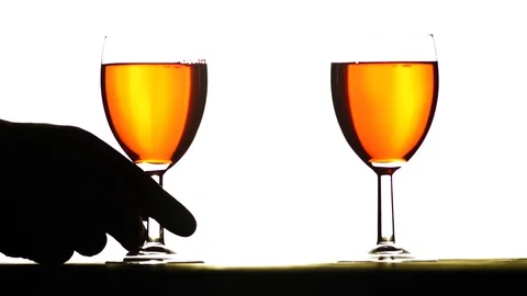 A glass of wine in a hand on a white background Vídeos de archivo 87948861