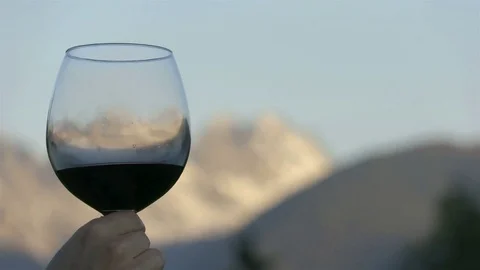 Glass of wine with the mountains on the background Stock Footage 76864066