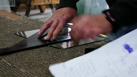 Glass worker cutting the 6 mm thick glass to dimension Stock Footage 312567964