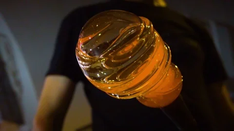 Glassblower in his workshop rotating rod with liquid glass. Close-up. Stock Footage 109719322