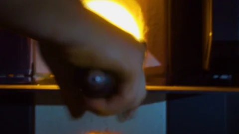 Glassblower in his workshop taking out rod with liquid glass and rotating it Stock Footage 109720186