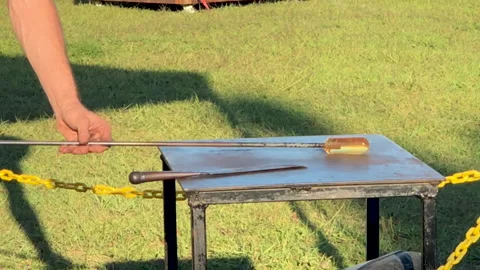 Glassblower rolling glass Stock Footage 210540030