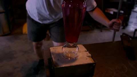 Glassblower Shaping Ruby Vase On Wooden Block, Hot Glass Studio, Medium Shot Stock Footage 341335997