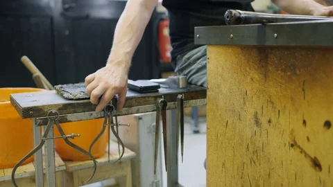 Glassblower smiling at camera while working in workshop Video stock 107927066