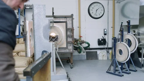 Glassblower using his equipments while at work in workshop Stock Footage 107932877