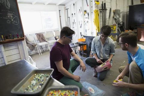 Glassblowers brainstorming in workshop Stock Photos