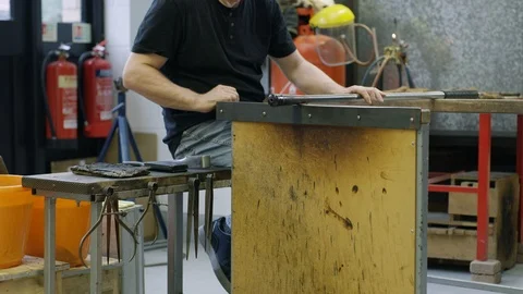 Glassblowers at work smiling at camera Stock Footage 107928851