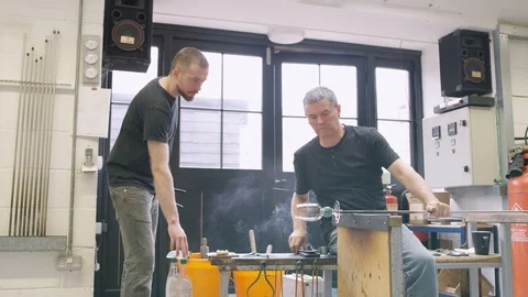 Glassblowers at work in workshop Video stock 107919846