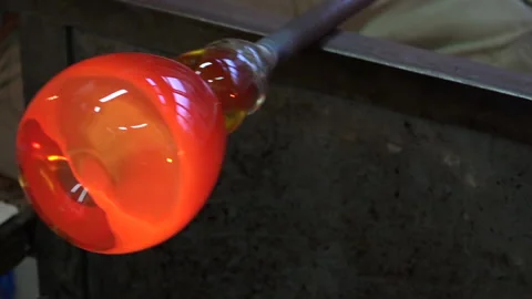 Glassblowing and a worker doing his job in a factory Stock Footage 239656686