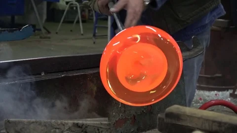 Glassblowing workshop creating vase glowing hot glassblower gaffer turning rod Stock Footage 77514438