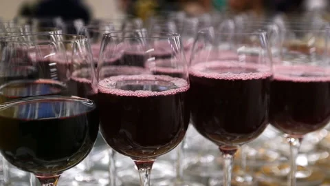 Glasses with alcohol and different drinks, glasses of wine and juice are on the Stock Footage 98232976