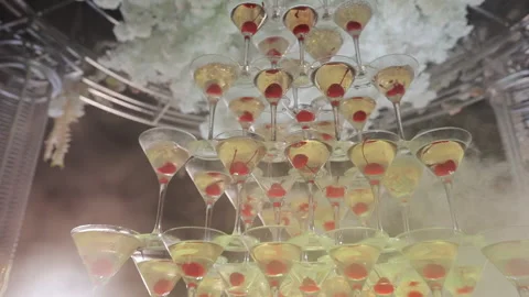 Glasses with alcohol and different drinks. Champagne tower at party celebrating Stock Footage 196003954