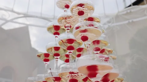 Glasses with alcohol and different drinks. Champagne tower at party celebrating Stock Footage 196006413