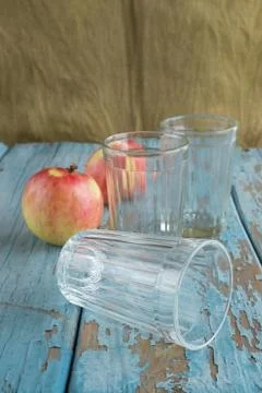 Glasses and apples on the table Stock Photos