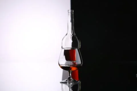 Glasses and bottles for brandy and wine in the background Stock Illustration
