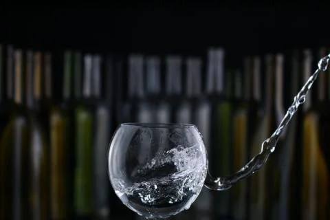 Glasses and bottles for brandy and wine in the background Stock Photos