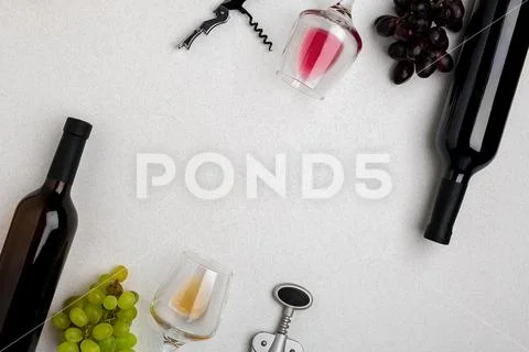 Glasses and bottles of red and white wine on white background from top view Stock Photos