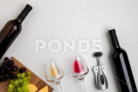 Glasses and bottles of red and white wine on white background from top view Stock Photos