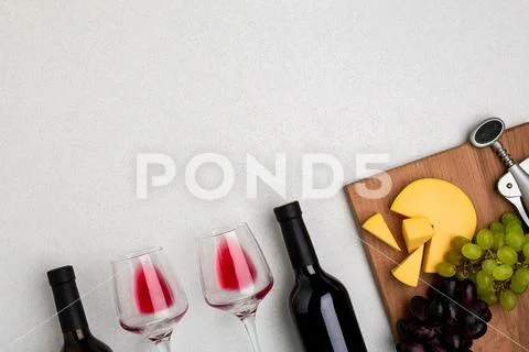 Glasses and bottles of red and white wine on white background from top view Stock Photos