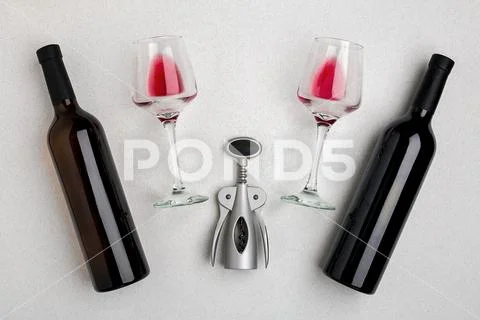 Glasses and bottles of red and white wine on white background from top view Stock Photos