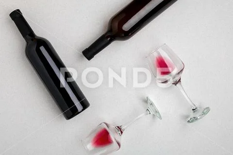 Glasses and bottles of red and white wine on white background from top view Stock Photos