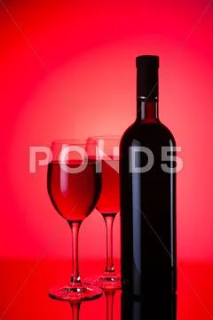 Glasses and bottles of red wine Stock Photos