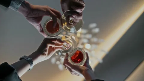 Glasses and goblets with alcoholic drinks are clinked after a toast Stock Footage 315230946