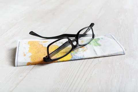 Glasses and map Stock Photos