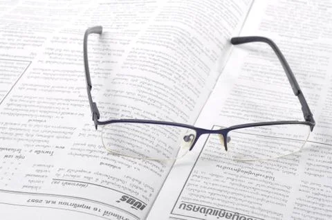 Glasses and newspaper Stock Photos
