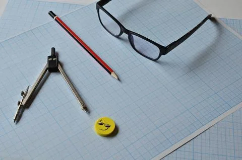 Glasses and objects for drawing on millimeter paper. Stock Photos