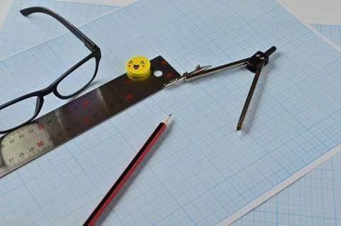 Glasses and objects for drawing on millimeter paper. Stock Photos