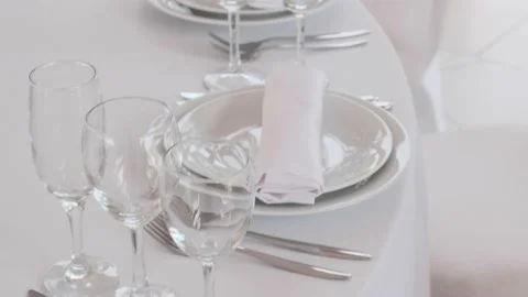 Glasses and plates on a white table Stock Footage 162032623