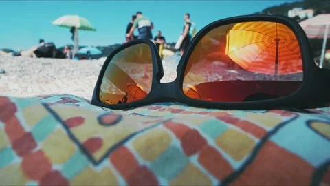 Glasses are on the beach. The reflection in the glasses. Time lapse. Rest and Stock Footage 143120455