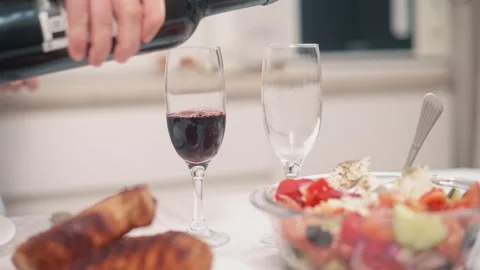 Glasses are being filled with wine. Stockbeeldmateriaal 343874081