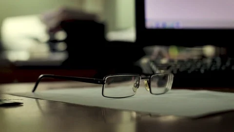 Glasses are on the desktop in the office Stock Footage 104669241