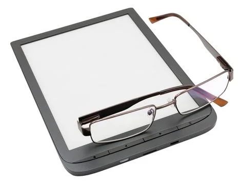 The glasses are lying on the book reader Stock Photos