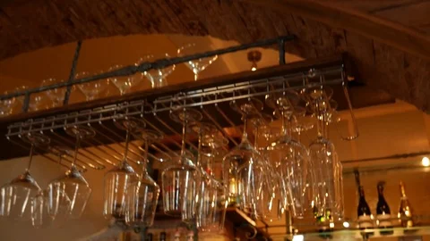 Glasses on a bar hanging upside down. The bar counter in the caf Stock Footage 73992547