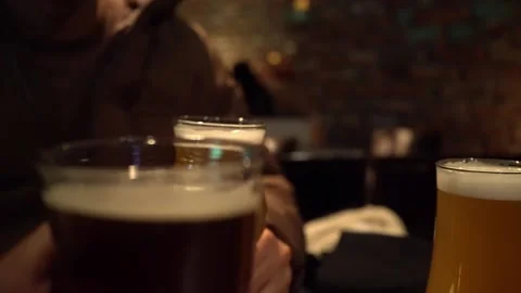 Glasses of beer held up for a toast Video stock 168464875