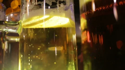 Glasses of beer sit on the table close up view from bottom to top on the foam. T Stock Footage 87425980