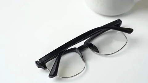 Glasses with black frames on white background Stock Footage 262434995