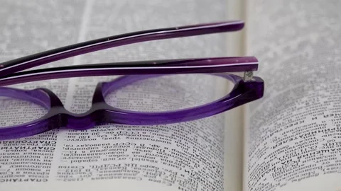 Glasses on a book close up Stock Footage 141373553
