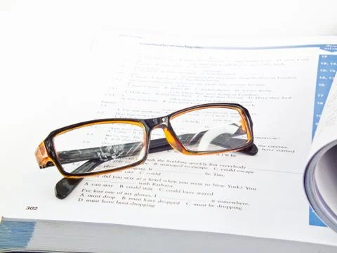 Glasses on book Stock Photos