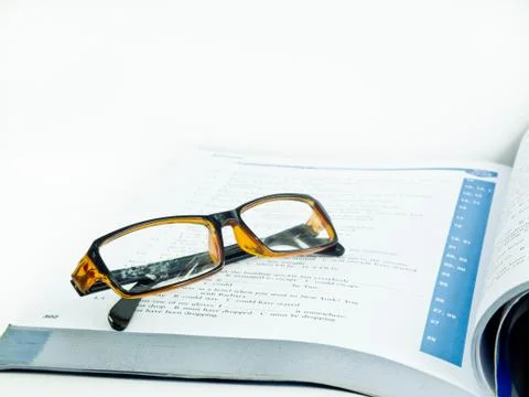 Glasses on book Фото