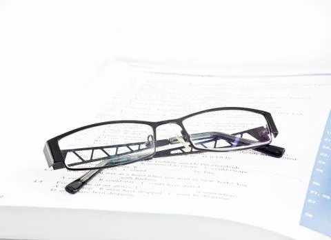 Glasses on book Stock Photos