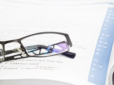 Glasses on book Stock Photos